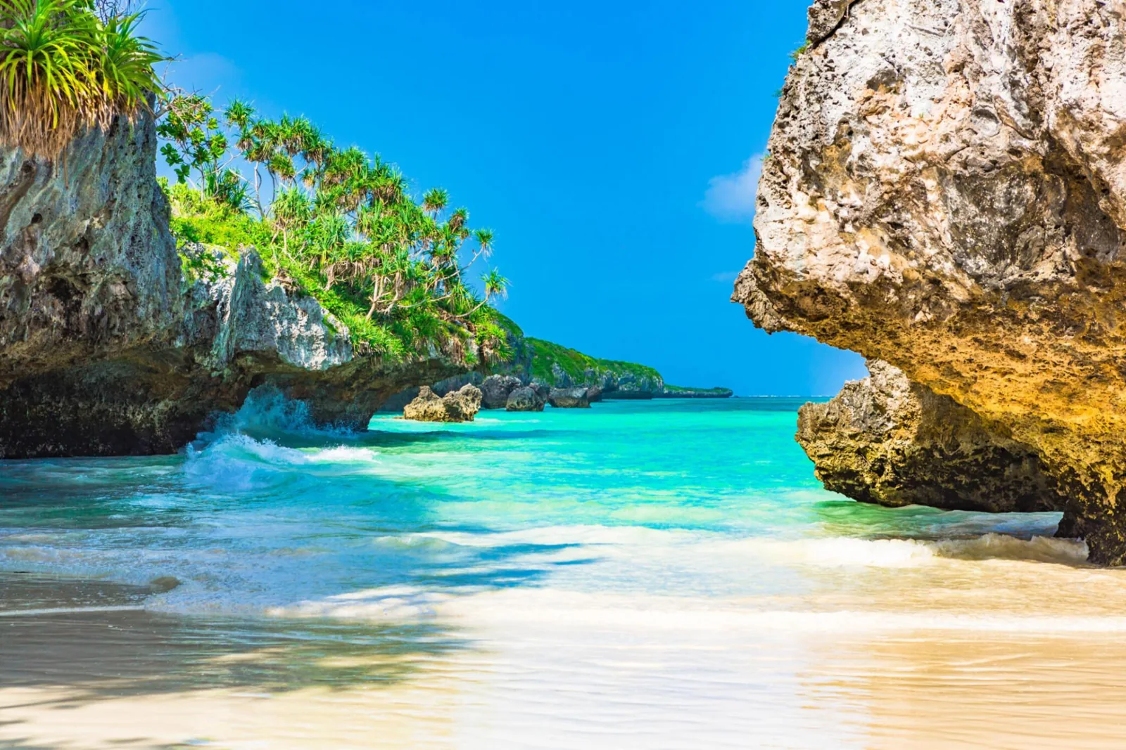 Coral rock formations and turquoise water at Mtende Beach