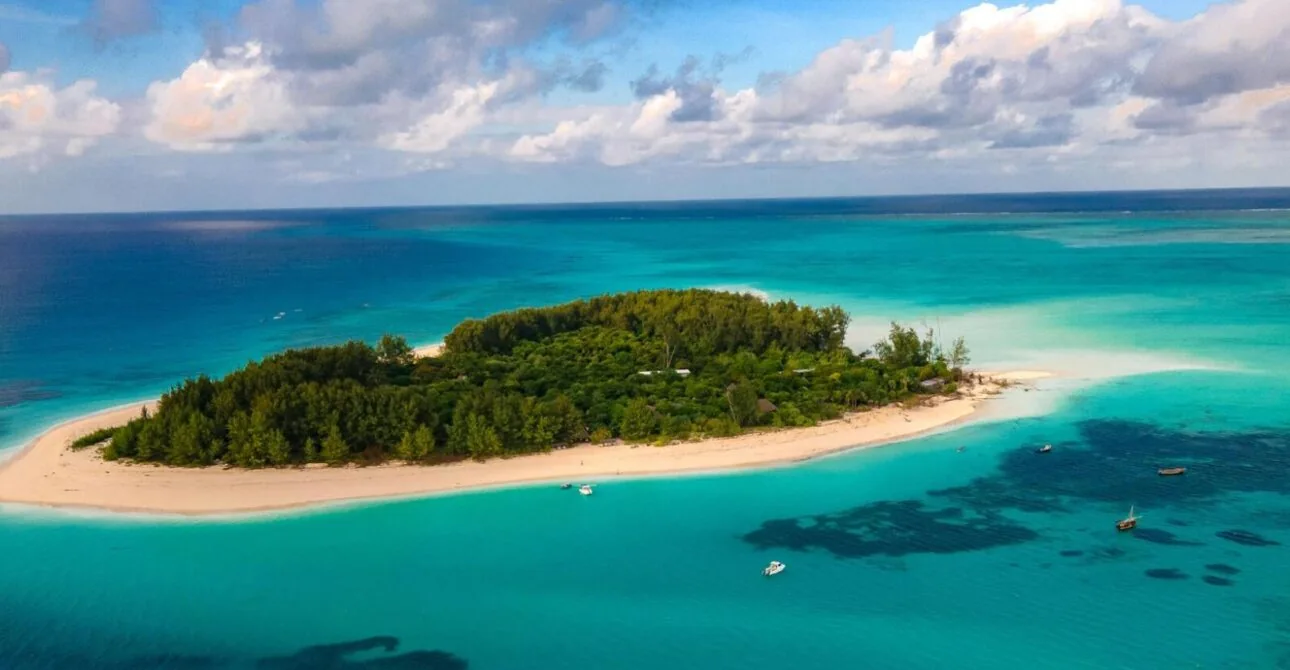 Aerial view of Mnemba Island surrounded by turquoise water